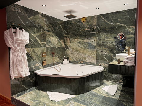 Salle de bain moderne de la Suite Cosy à l’hôtel Van der Valk Nivelles-Sud, avec bain à remous, douche effet pluie et accès à l’espace bien-être pour un séjour relaxant.